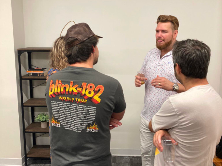 Todd from Baxus discussing whiskey tasting with three people