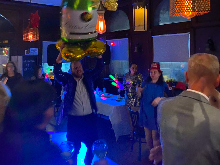 People dancing in blue lighting at Ravyn & Robyn