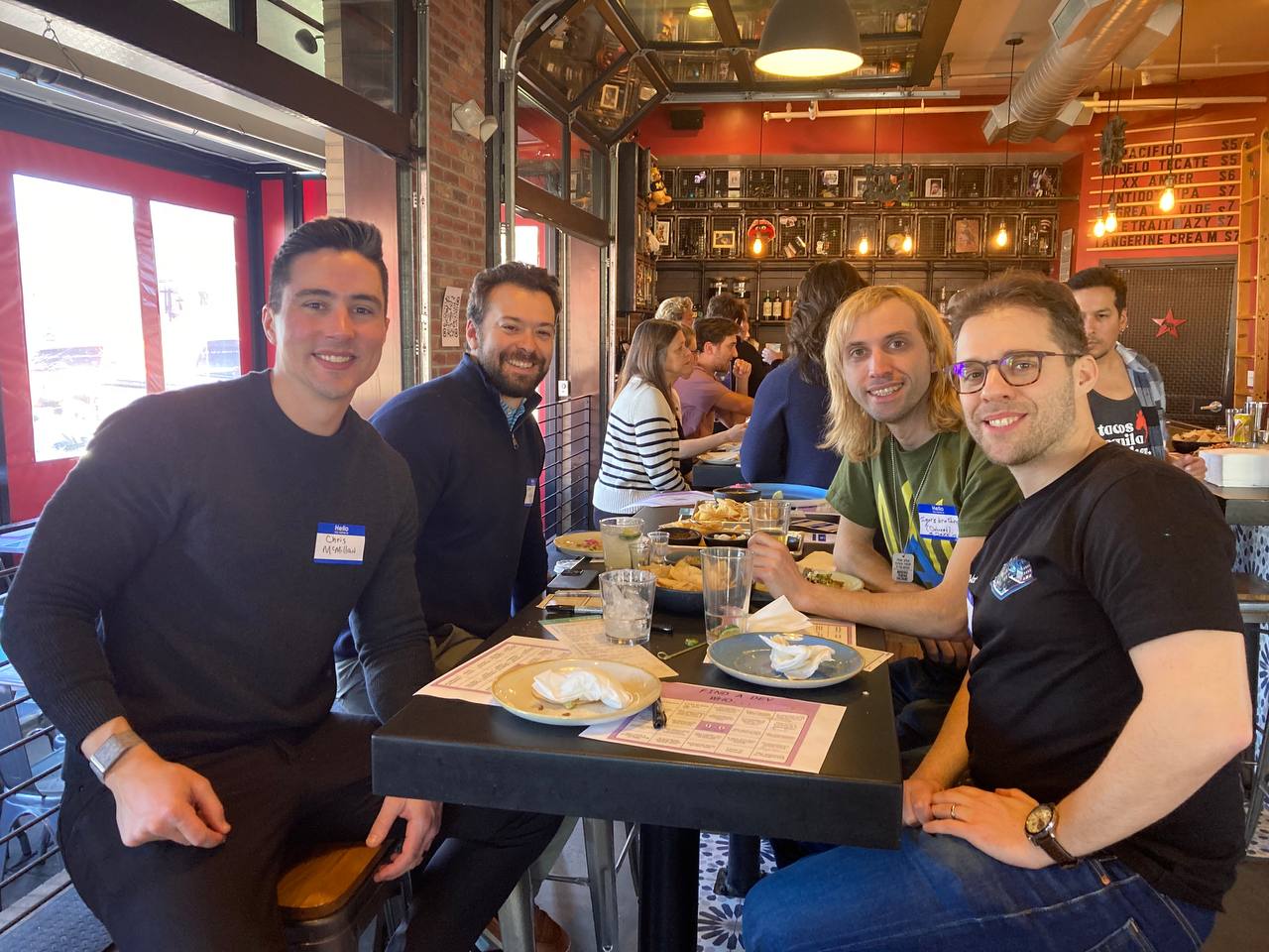 A picture of attendees networking around a table.