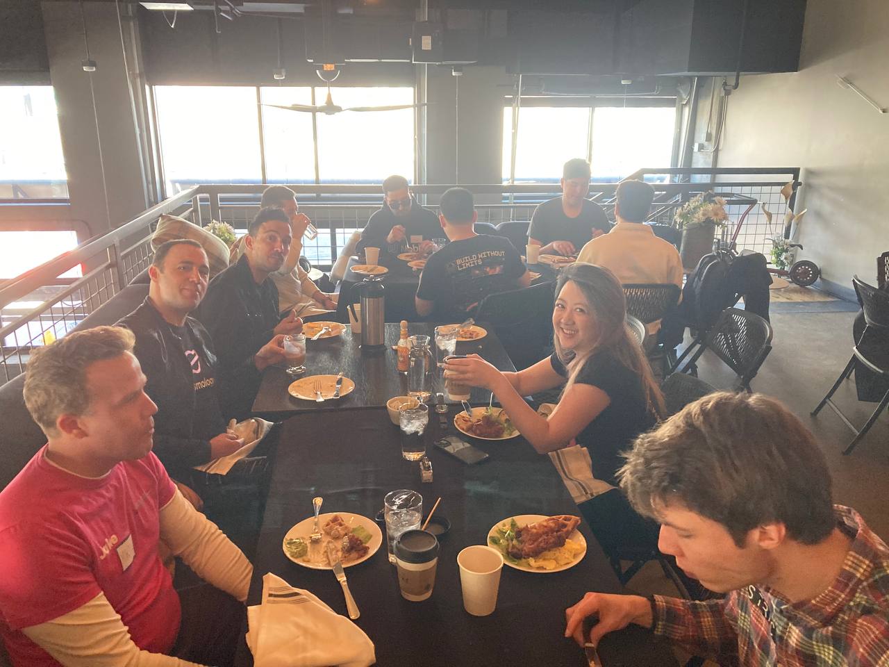 A picture of attendees networking while eating brunch.